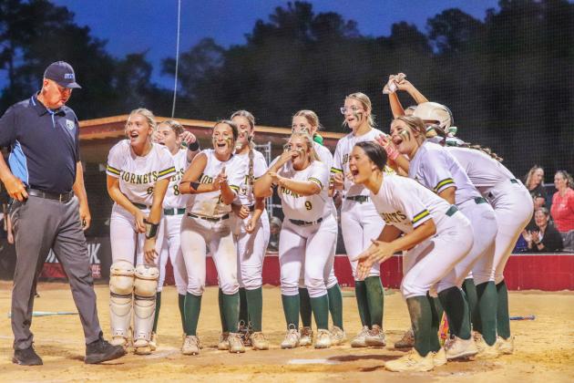 Lady Hornet softball players await Carmen Overstreet at home plate after she knocked a homerun in Wednesday’s regional tournament win over the West Nassau Warriors.Photo by Amanda Bishop/Nassau County Record