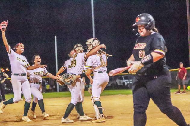Lady Hornet softball players celebrate after making the final out in Wednesday’s regional tournament win over the West Nassau Warriors. Photo by Amanda Bishop/Nassau County Record