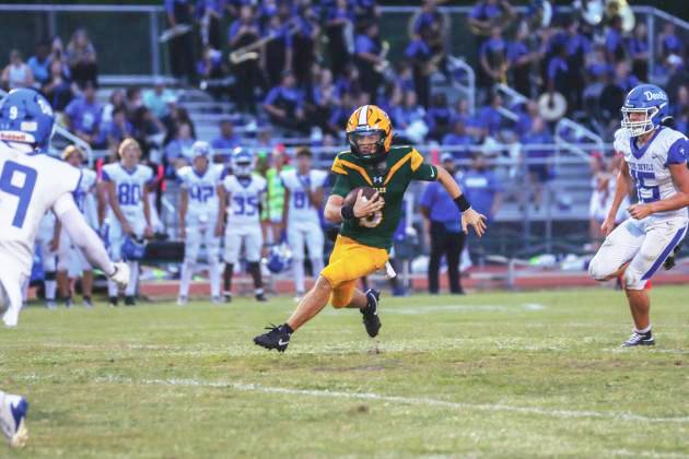 Yulee High School’s quarterback Tre Vazquez carries the ball in a game last season. Photo by Ashley Chandler/News-Leader