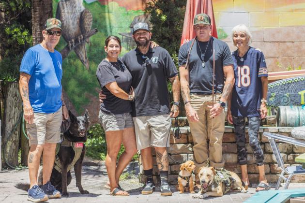 From left, Rick Ludwig with his dog Raven, Angela Young, Matt Tarlton with Copper, Scott Lempe’s dog, Thomas Gritzner with Payton and his caretaker, Anna Gritzner.