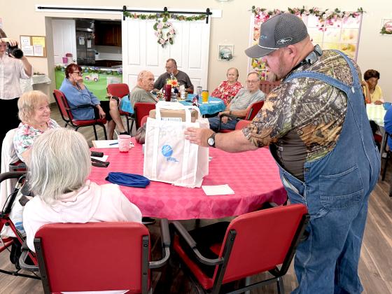 Nassau County Commissioner Klynt Farmer hands out a hurricane preparedness kit on Monday.