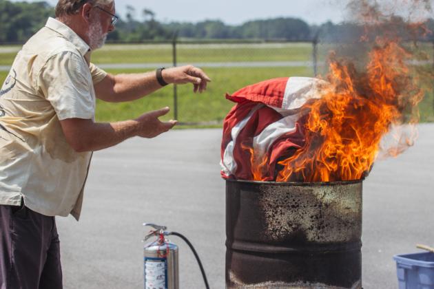 ruce Senter, husband of a Daughter of the American Revolution retires a flag Saturday. Photo by Ashley Chandler/News-Leader