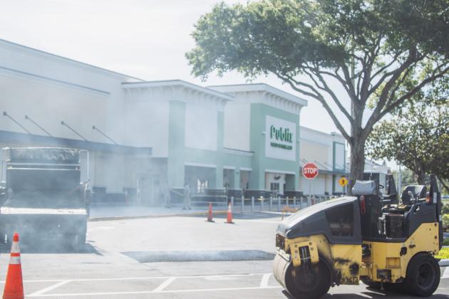 Duval Asphalt puts finishing touches on the Publix parking lot Thursday. Johnson said they did all the paving and printing of the lot. Publix has officially announced it will open on July 2. Photo by Ashley Chandler/News-Leader