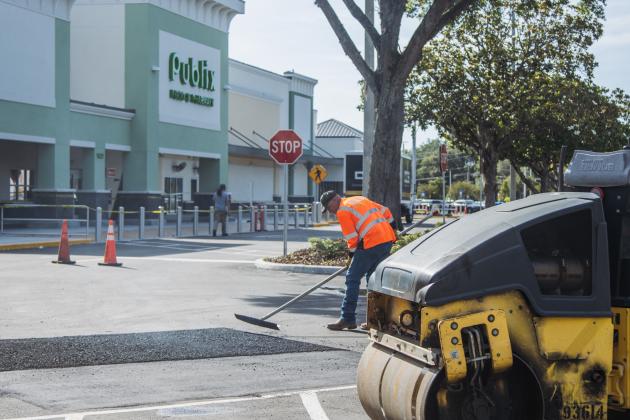 Donald Johnson of Duval Asphalt puts finishing touches on the Publix parking lot Thursday. Johnson said they did all the paving and printing of the lot. Publix has officially announced it will open on July 2. Photo by Ashley Chandler/News-Leader