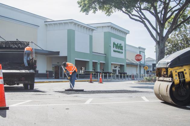 Donald Johnson, right, and Dalton Pinner of Duval Asphalt put finishing touches on the Publix parking lot Thursday. Johnson said they did all the paving and printing of the lot. Publix has officially announced it will open on July 2. Photo by Ashley Chandler/News-Leader