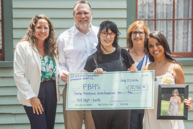 The fourth annual Fernandina Beach Art Department fundraiser and silent auction raised nearly $13,000 for the school program. From left, Antoinette Ferry, Todd McDonald, Joy Keith, Diane Smith and Esmerelda McDonald pose with and a photo of Jill Wilkinson and the ceremonial check presented to Keith for the Fernandina Beach Art Department. Photo by Ashley Chandler/News-Leader