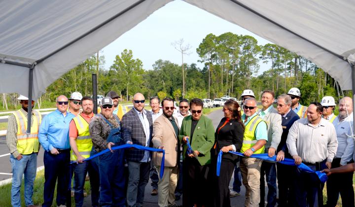 Nassau County School Superintendent Kathy Burns cuts the ribbon for Hornets Drive, formally know as William Burgess Extension. Photo courtesy of Nassau County