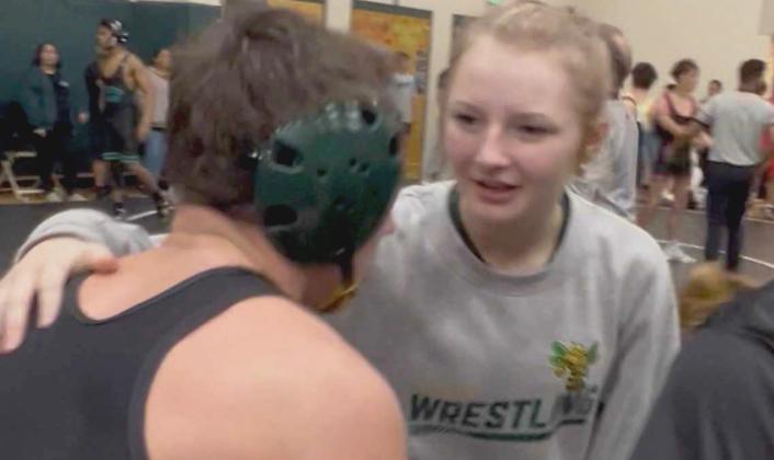Journey Flannery, right, talks to Lucas Flannery between matches at a high school wrestling meet. Submitted