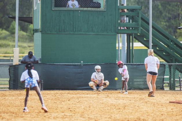A Yulee High School Softball Camp participant takes a swing at pitch Thursday morning. Photo by Ashley Chandler/News-Leader