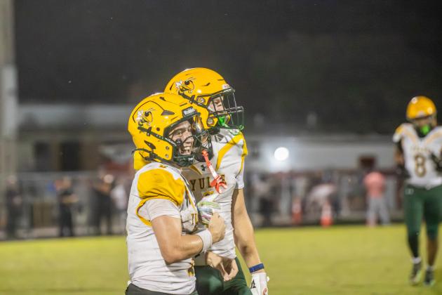 Tre Vazquez and Pete Kuhlman celebrate after a play in an Aug. 21 game against Baldwin. Photo by Nick Blank/News-Leader
