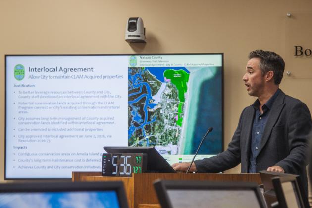Nassau County Conservation Land Manager Taylor Clem speaks at the July 27 BOCC meeting about the Interlocal Agreement between Nassau County and the City Fernandina Beach that passes maintenance responsibility of certain CLAM properties purchased in city limits to the Fernandina Beach government. Photo by Ashley Chandler/News-Leader