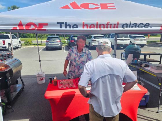 Greg Edwards, owner of Amelia Island BBQ Company, talks with a Turner ACE Hardware customer Saturday. Photo by Suzi Hamilton/For the News-Leader