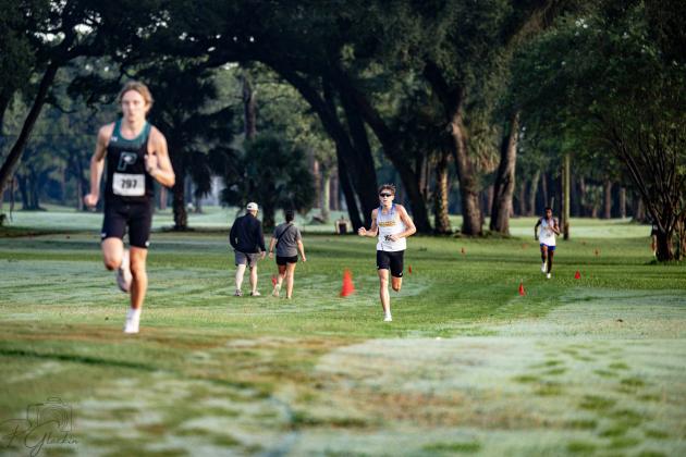 Fernandina Beach High School juniors John William Martin, middle, and Malik Ravenell, right, follow behind Providence senior Sean Cunningham on Saturday during the Coach Hope Memorial Invitational. The three runners finished first, second and third. Photo by Penny Glackin/For the News-Leader