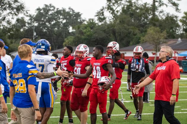 Nassau County and Duval County school officials coordinate the pregame handshake Friday between the Fernandina Beach High School and Andrew Jackson High School varsity football teams. Nick Blank/News-Leader