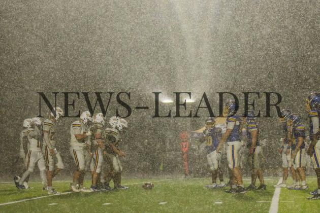 Pirates meet Union County football players at the line of scrimmage as rain pours down on Thursday night at Fernandina Beach High School stadium. Photo by Ashley Chandler/News-Leader