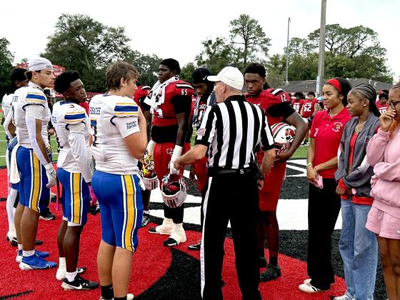 Fernandina Beach High School and Andrew Jackson High School football players greet each other at midfield, exchanging handshakes before Friday’s game. photo by Nick Blank/News-Leader