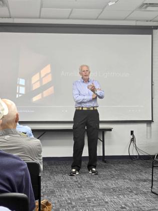 Robert Eberle, a 10-year resident of the island who is a former Associated Press photographer, talks about the documentary he made about the Amelia Island Lighthouse. Photo by Ashley Chandler/News-Leader