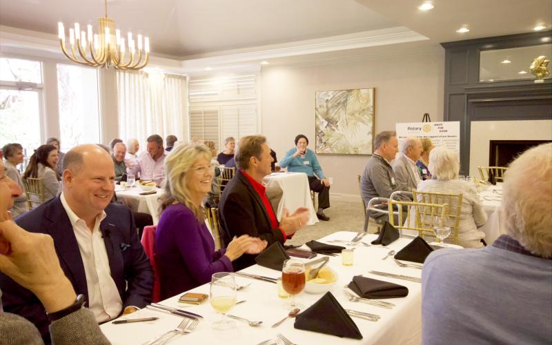 Jason Mudd sits next to Nassau County Commissioner Jeff Gray, and Jeff’s wife, Diana Gray, at the Fernandina Beach Rotary Club’s annual Scholarship Luncheon at the Amelia Island Golf Club on March 19. By Marisa DeMar/News-Leader