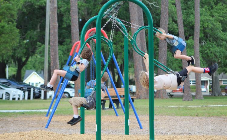 Children enjoy a morning spent at Central Park, challenging each other to swing higher and higher.