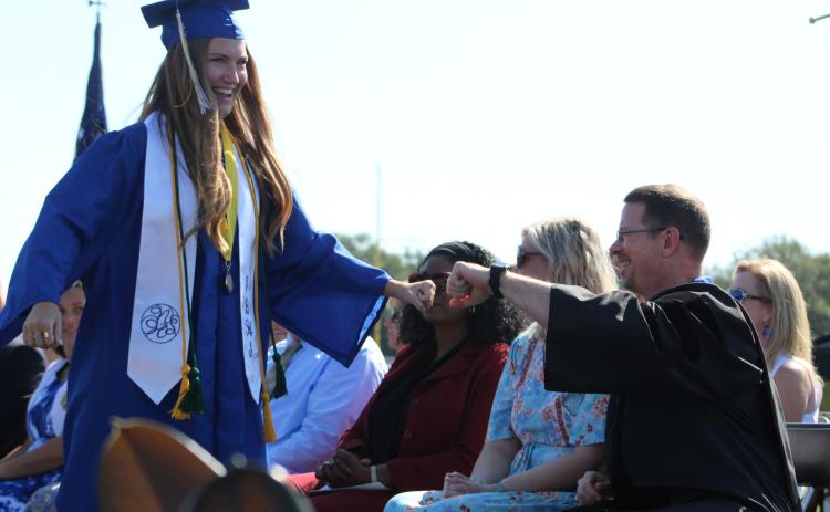 Fernandina Beach High School graduate Kallie Johns acknowledges Teacher of the Year James Glacklin before collecting her diploma Saturday morning.