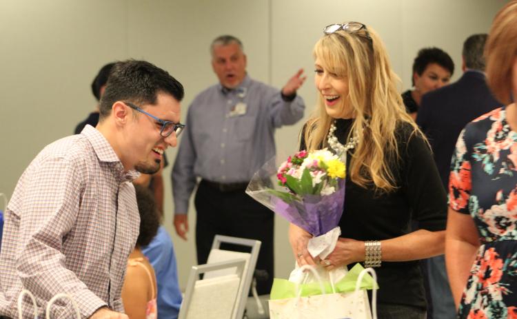 Project SEARCH instructor Lisa Mallo laughs with graduate Zachary Strickland at Tuesday’s ceremony.