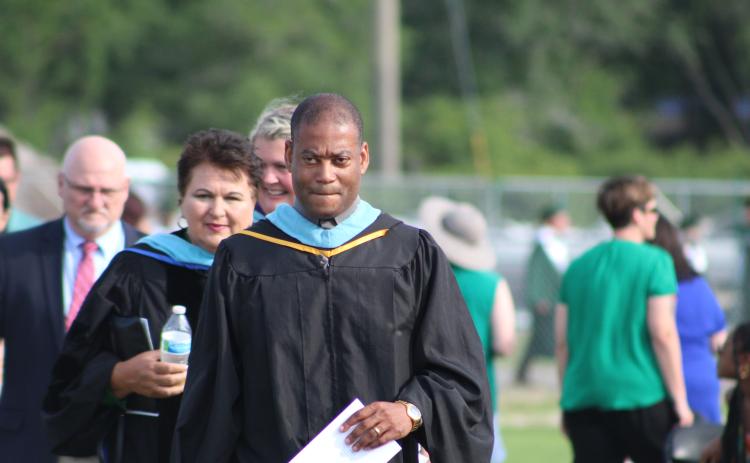 Yulee High School principal Roody Joinville leads a procession prior to the school’s graduation May 25.