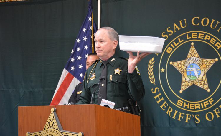 Sheriff Bill Leeper holds up a bucket of flour to demonstrate the amount of fentanyl seized in Operation Heavy Weights. Photo by Holly Dorman/News-Leader.