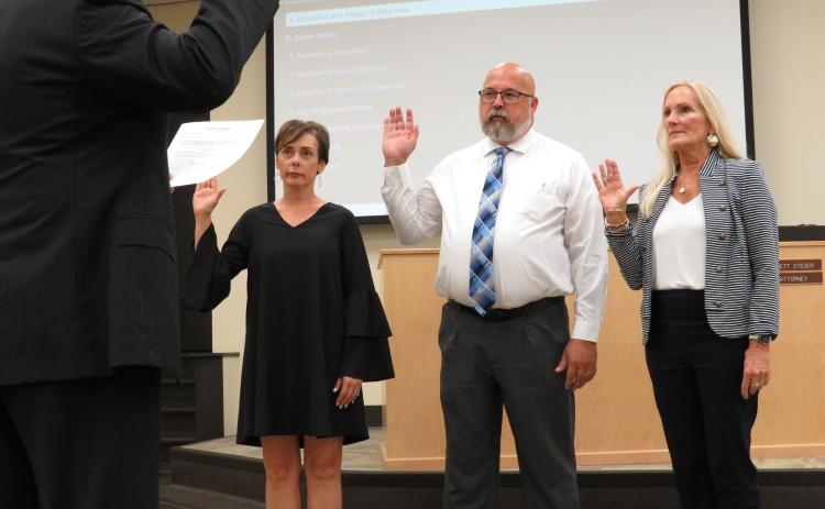 Shannon Hogue, Curtis Gaus and Lissa Braddock are sworn in as members of the Nassau County School Board by board attorney Brett Steger.