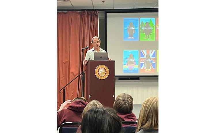 Author Stuart Gibbs talks with St. Michael Academy students about his book series.
