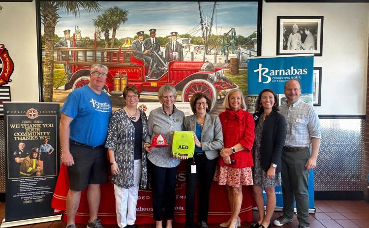 Pictured are, from left,  Barnabas board member John Mullman, Barnabas board member Maureen Paschke, Barnabas board member Liza Cotter, Firehouse Subs Public Safety Foundation Executive Director Robin Peters, Barnabas President and CEO Jamie Reynolds, Baptist Health Community Relations coordinator Avalee Delay, and Barnabas board member Rev. Joe Woodfin. Photo courtesy of Barnabas Center