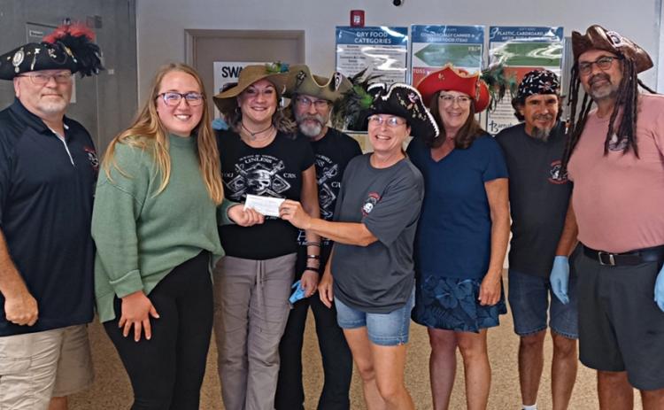 Pictured are, from left, Greg Carter (Pirate public relations chair, Teller of Tales, aka Big G), Barnabas representative Noel Lehman (Pirate, aka Kalypso), Charles Lehman (Pirate, aka Captain Kaz), Juleeann Stewart (Pirate Treasurer, Keeper of Coins, aka Jewels of the Island), Gwen Cox (Pirate, aka Ember), Brian Leary (Pirate, aka Swordmaster) and Robert Chestnut (Pirate, aka Bob).