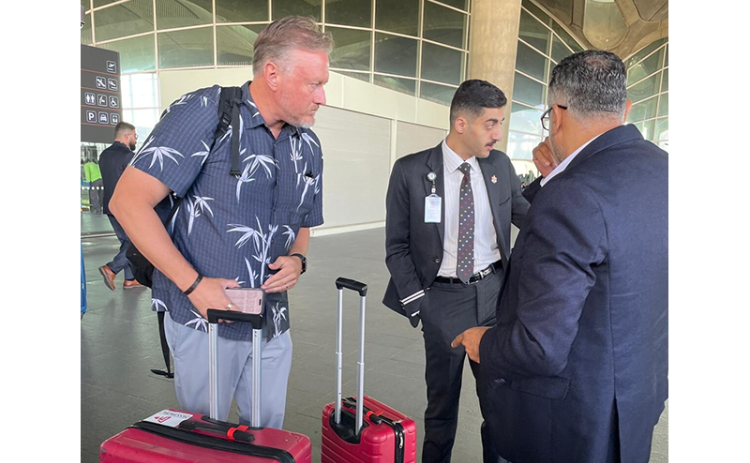 Pastor Zach Terry speaks with officials as he tries to get his group home from Israel. Submitted photo