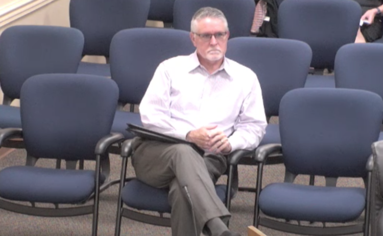 Agent Doug Smith listens to public comment in opposition of his company’s application for a conditional use permit for the sale of beer and wine at a site at the southeast corner of Meadowfield Bluffs Road and SR 200. Photo by Sean Rosenthal/News-Leader