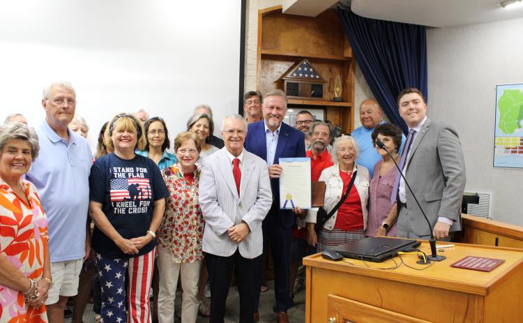 First Baptist Church of Fernandina Beach pastor Zack Terry holds a proclamation presented to him and John Meisburg establishing June 29 as Christian Heritage Day. There is a Christian Heritage parade scheduled for that day. Participants are being asked to submit a form requiring they agree with certain religious beliefs, which some people being is causing division in the community. Photo by Julia Roberts/News-Leader