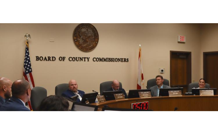 From left, commissioners Klynt Farmer, John Martin, Jeff Gray and Alyson McCullough listen as Assistant County Manager Marshall Eyerman, far left, talks Monday at the Board of County Commissioners meeting. Eyerman said a grant the county accepted Monday will cover most of the cost of a 48–foot Coastal Fast Response Boat Fire Rescue vessel. Photo by Ashley Chandler/News-Leader