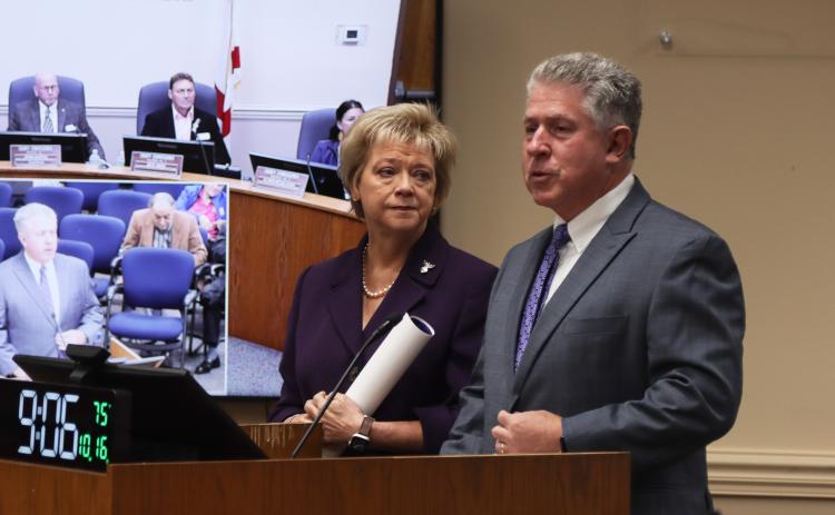 Doug Adkins, right, talks Oct. 16 at the Nassau County Board of County Commissioners meeting after the board proclaimed October 2024 as Emily Adkins Blood Clot Awareness Month. Janet Adkins, Supervisor of Elections, right, listens. Photo by Ashley Chandler/News-Leader