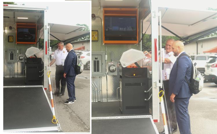 Nassau County Fire Rescue Fire Chief Brady Rigdon shows County Manager Taco Pope some of the functionality of the outdoor grill on the new Fire Safety Education Trailer recently procured by Nassau County Fire Rescue and the Fernandina Beach Fire Department.  Photos by Ashley Chandler/News-Leader