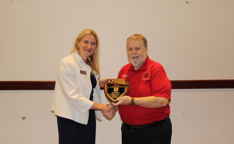 Miriam Hill presented a plaque to Danny Fullwood from the Ocean Highway and Port Authority, thanking him for his long tenure on the port authority’s commission. Photo by Julia Roberts/News-Leader