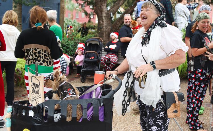 The Lady Judith, Judie Mackie, is pictured dressed in her pirate PJs with her furry friend at the Black Friday Pajama Party. Several members of the Fernandina Pirates Club took part in the pajama contest Friday. Photo by Ashley Chandler/News-Leader