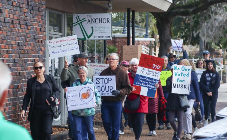 Protesters were Downtown on Thursday to voice their opinion on Social Security, DOGE and Elon Musk to Congressman Aaron Bean and his staff. On left, is Nassau County Democratic Party Chair Suzanne Sapp. Photo by Ashley Chandler/News-Leader