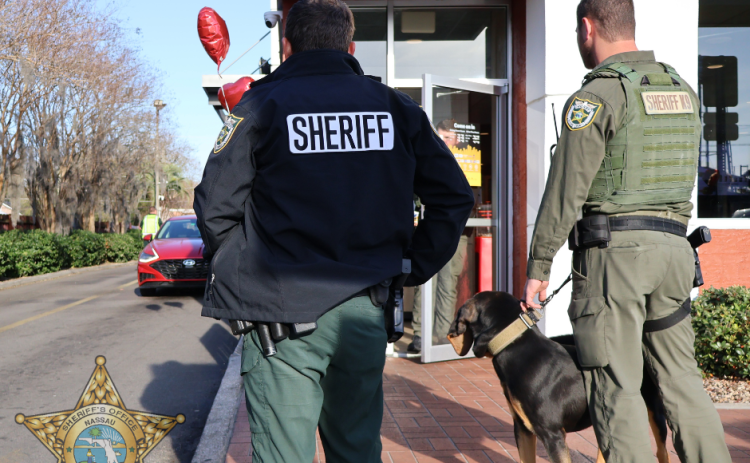 Nassau County Sheriff’s Office Deputy Daniel Jones, left, and Corrections Deputy Jacob Deal with K9 Rip at the Valentine’s Day event Hearts and Heroes at the Callahan McDonalds. The McDonald's partnered with the NCSO to raise funds for Special Olympics in conjunction with the NCSO Law Enforcement Torch Run. Submitted photo