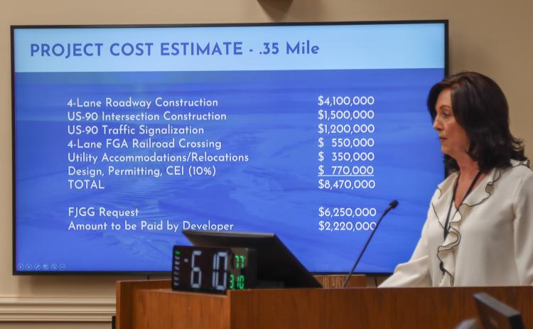 Holly Coyle, on Monday in the Commission Chambers, presents to the Board of County Commissioners a grant application for a $6.25 million grant that would fund a 4-lane roadway to connect 700 acres of industrial and commercial land. Photo by Ashley Chandler/News-Leader