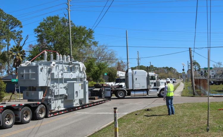 The driver of a double trailer truck maneuvers a 97,000-pound transformer around the corner of Lime and 10th streets to deliver to the substation. Photo by Ashley Chandler/News-Leader