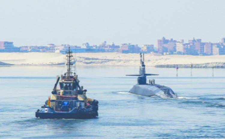 Mass Communications Specialist Seaman Christian Kibler | U.S. Navy The Ohio-class cruise missile submarine USS Georgia (SSGN 729) transits the Suez Canal on Sept. 9, 2024, while being escorted by the Arleigh Burke-class guided missile destroyer USS Michael Murphy (DDG 112).