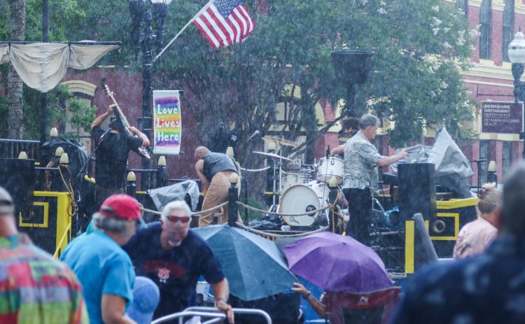 On Friday, the Sounds on Centre music series began as usual, but only three songs into Tommy Peacock’s set, the rain came crashing down on Centre Street. The concert did not resume. Photos by Ashley Chandler/News-Leader