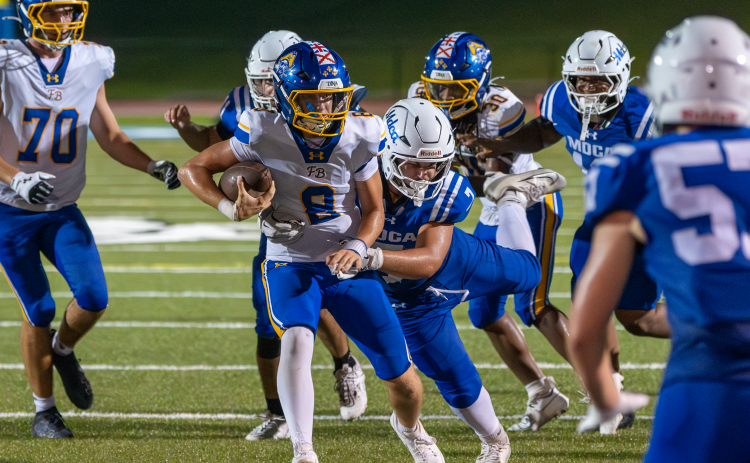 Fernandina Beach High School Football Quarterback Ian Miller carries the ball in Pirates first game of the season at Mount Dora Christian Academy on Aug. 15. Photo by Dana O’Connor/Special to the  News-Leader