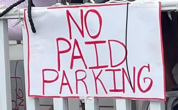 No paid parking sign hung outside local business, Ash Street Cigars