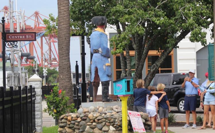 Children pose in front of the statue on Aug. 29 after the discussion of possible cremains took place. Marisa DeMar/News-Leader