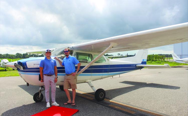 Jack Bishop and Zac Iseminger in front of aircraft at Fernandina Beach Municipal Airport on Aug. 28.