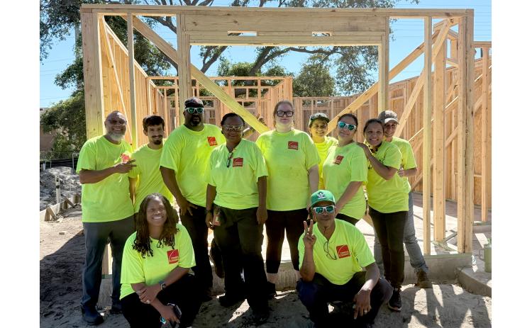 Owens Corning employees stand by the framing of a Habitat for Humanity home they worked on Friday, Sept. 5. Nick Blank/News-Leader